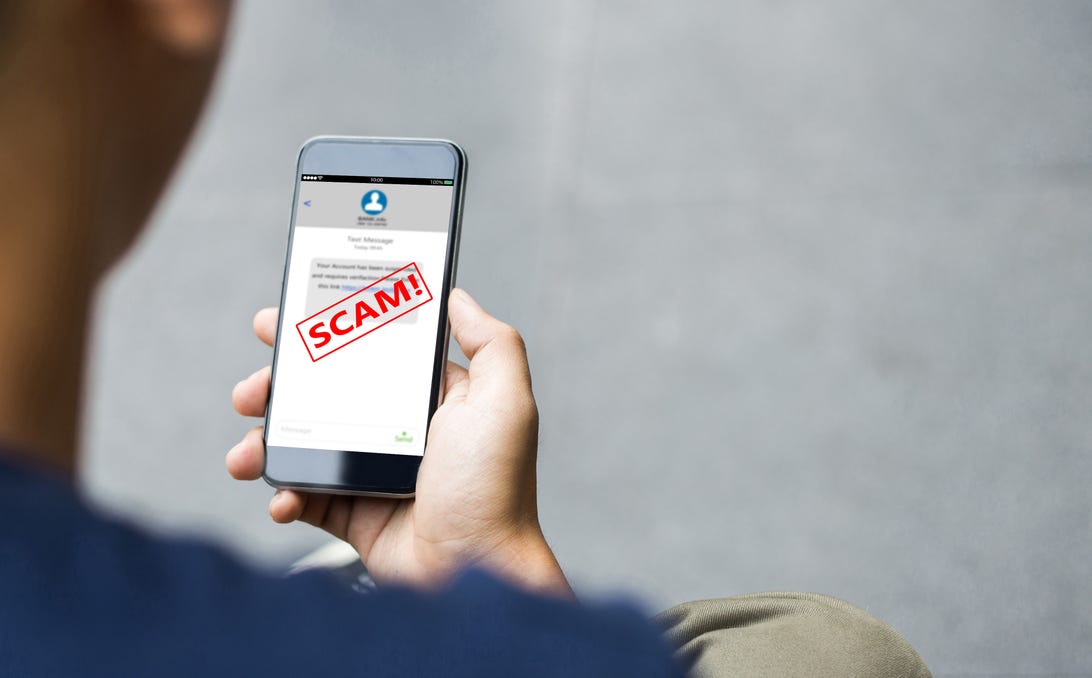 Cell phone showing scam alert.