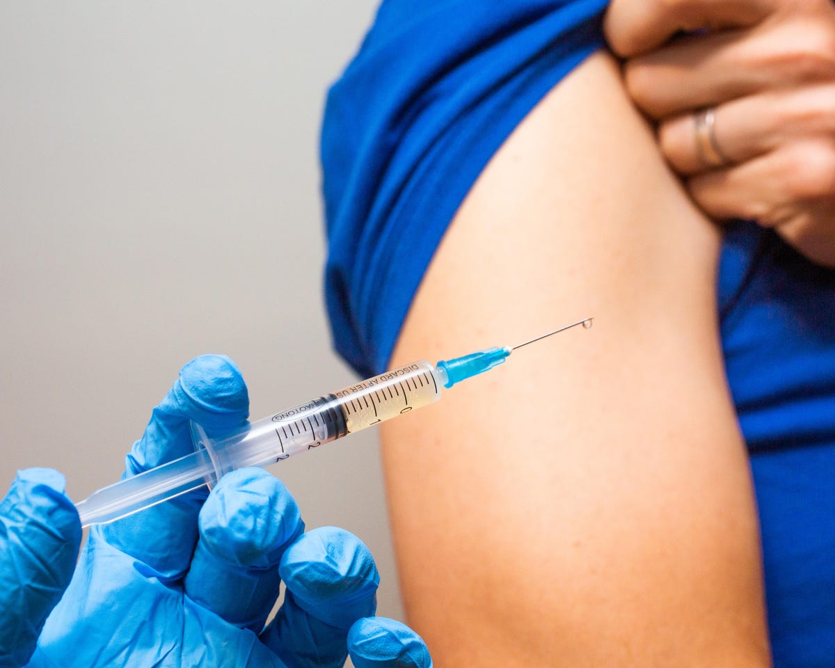 Syringe in a gloved hand