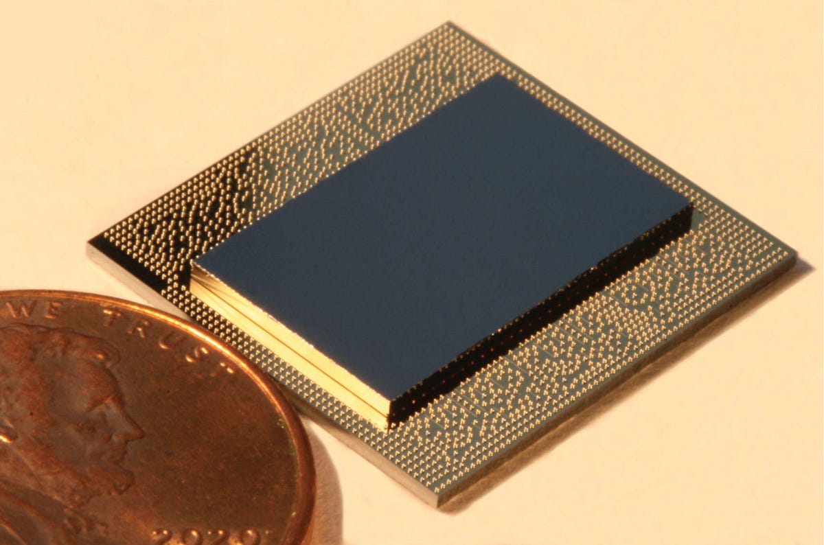 IBM's Falcon quantum computing chip is shown next to a penny.